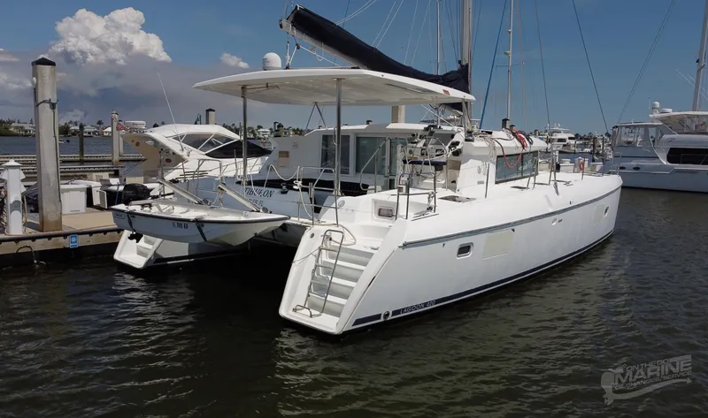 Slide: The Image of 2008 Lagoon 420 catamaran docked at marina, featuring sleek design and spacious deck. - 4