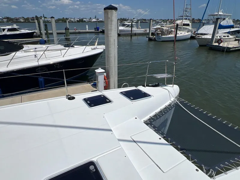 Slide: The Image of 2008 Lagoon 420 catamaran docked at a marina with other boats. - 41