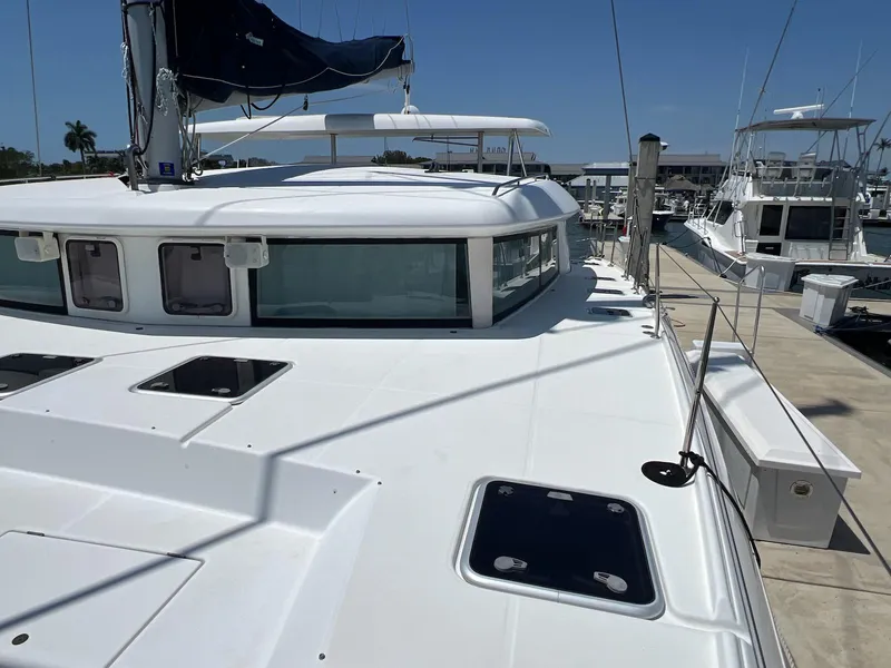 Slide: The Image of 2008 Lagoon 420 catamaran docked at marina under clear blue sky. - 42