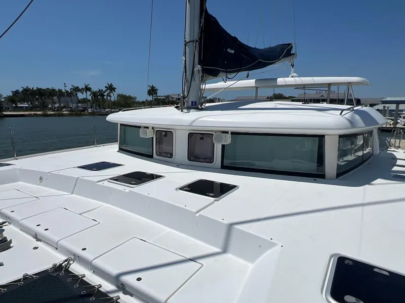 Slide: The Image of 2008 Lagoon 420 catamaran on water, featuring sleek design and spacious deck. - 43