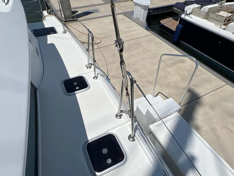 Slide: The Image of 2008 Lagoon 420 yacht deck view at marina, showcasing sleek design and mooring setup. - 46