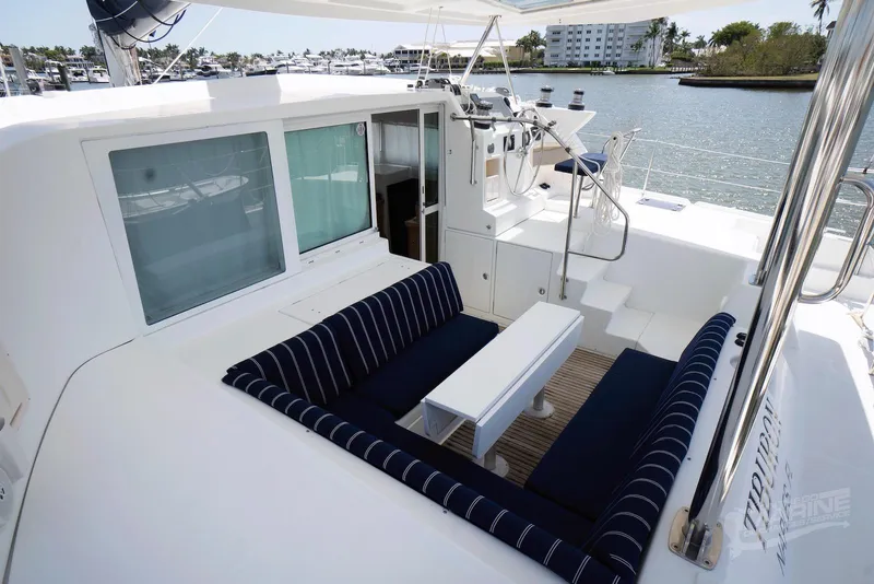 Slide: The Image of Lagoon 420 catamaran deck with seating area, 2008 model, docked by waterfront. - 49
