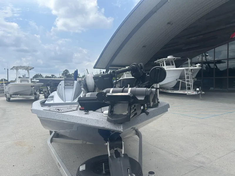 Slide: The Image of 2021 Xpress X19 Pro boat displayed outside a showroom with other boats. - 11