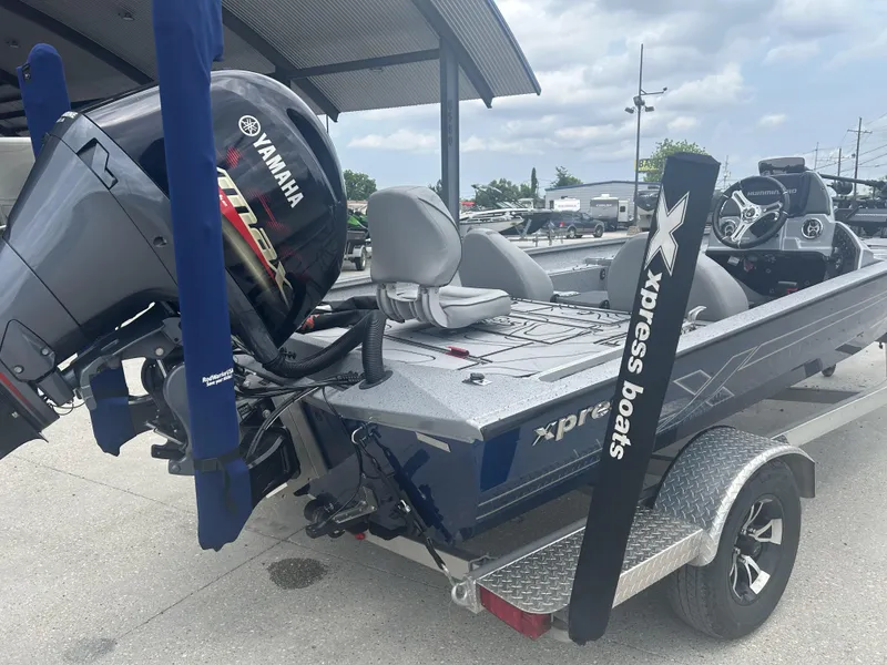 Slide: The Image of 2021 Xpress X19 Pro boat with Yamaha engine on trailer, parked outdoors. - 5