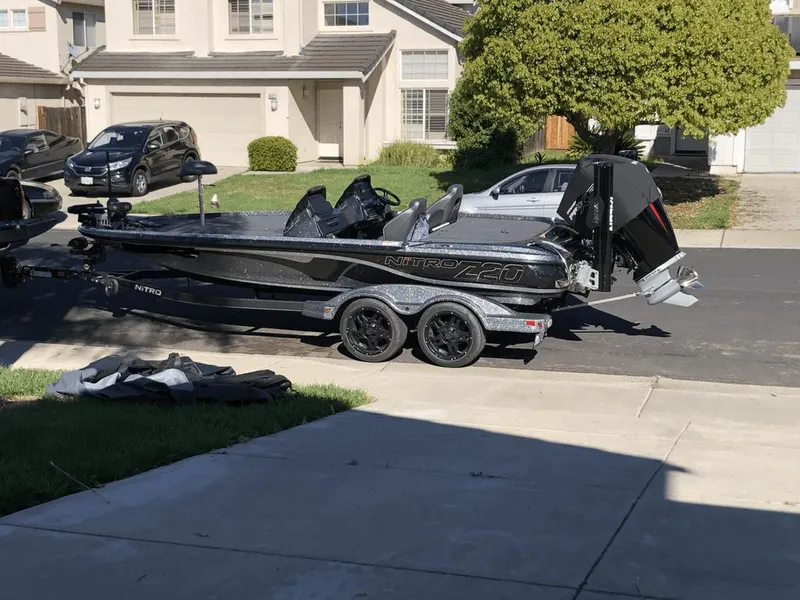 Slide: The Image of 2020 Nitro Z20 boat on trailer parked in residential driveway. - 11
