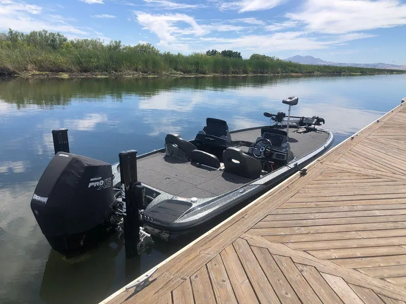 Slide: The Image of 2020 Nitro Z20 boat docked on calm lake with clear sky. - 5