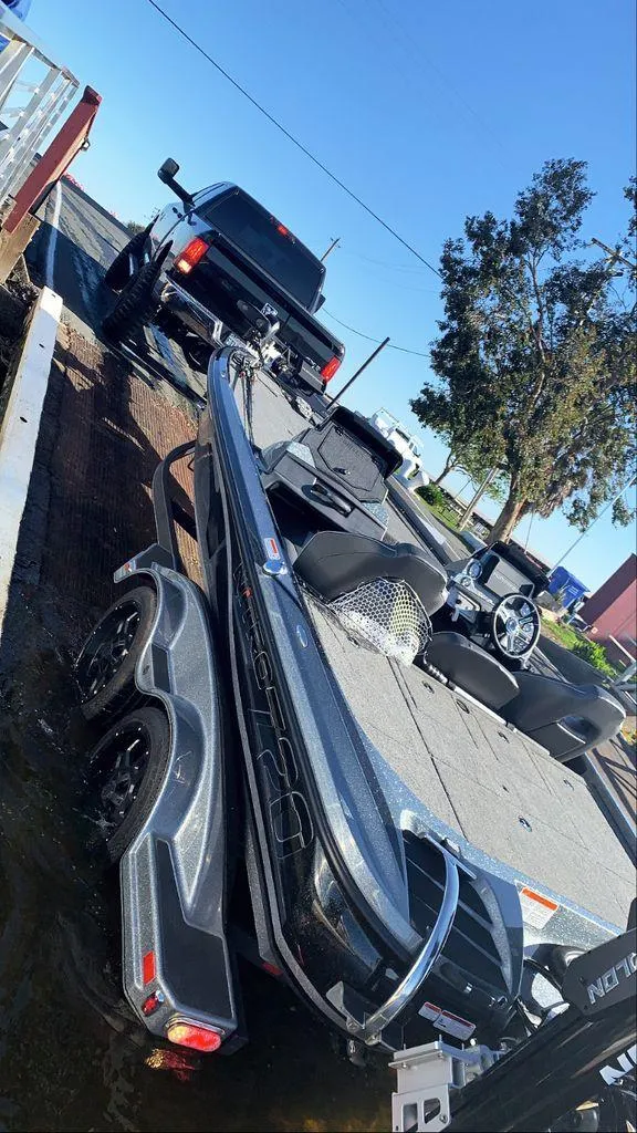 Slide: The Image of 2020 Nitro Z20 boat on trailer, being towed by a truck at a boat ramp. - 6