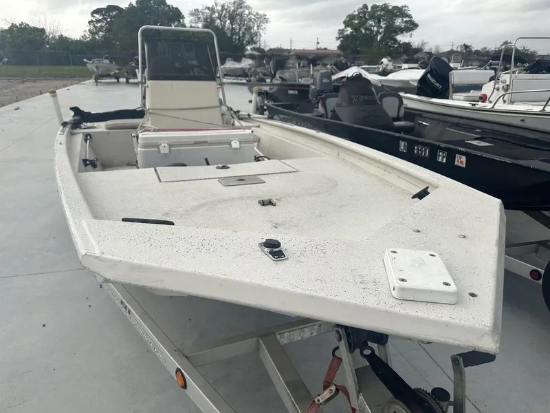 Slide: The Image of 2011 Xpress 18 CC boat on trailer, parked outdoors, overcast sky. - 2