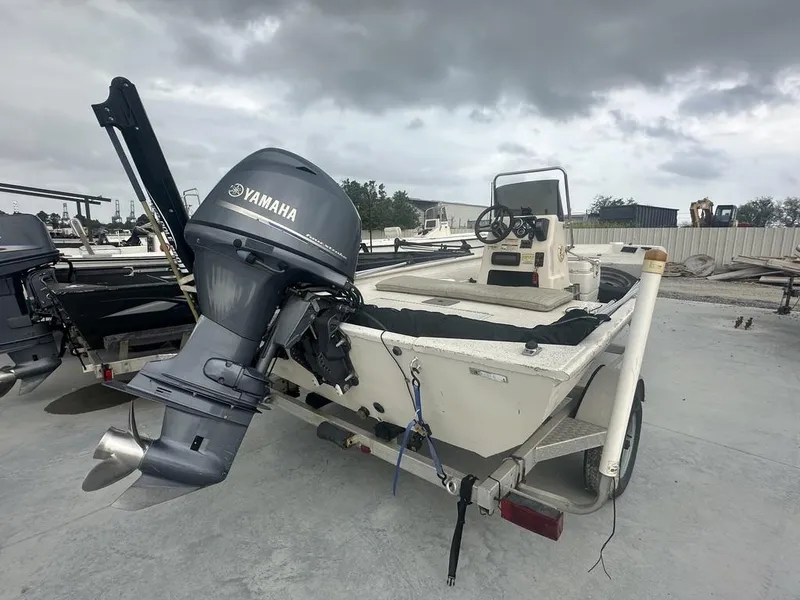 Slide: The Image of 2011 Xpress 18 cc boat with Yamaha outboard motor on trailer, under cloudy sky. - 5