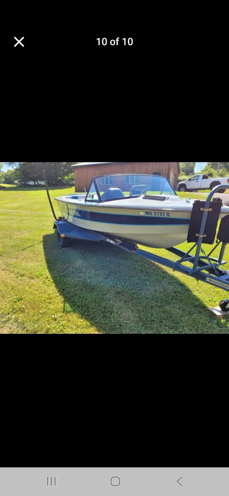 Slide: The Image of 1986 Correct Craft Ski Nautique boat on trailer, parked on grass. - 1