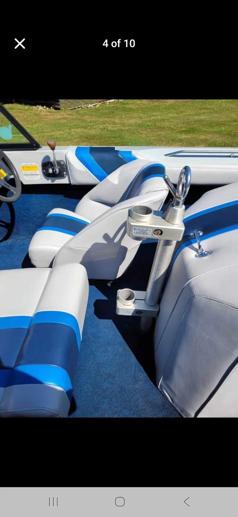 Slide: The Image of 1986 Correct Craft Ski Nautique interior with blue and white seats, steering wheel, and cup holders. - 4
