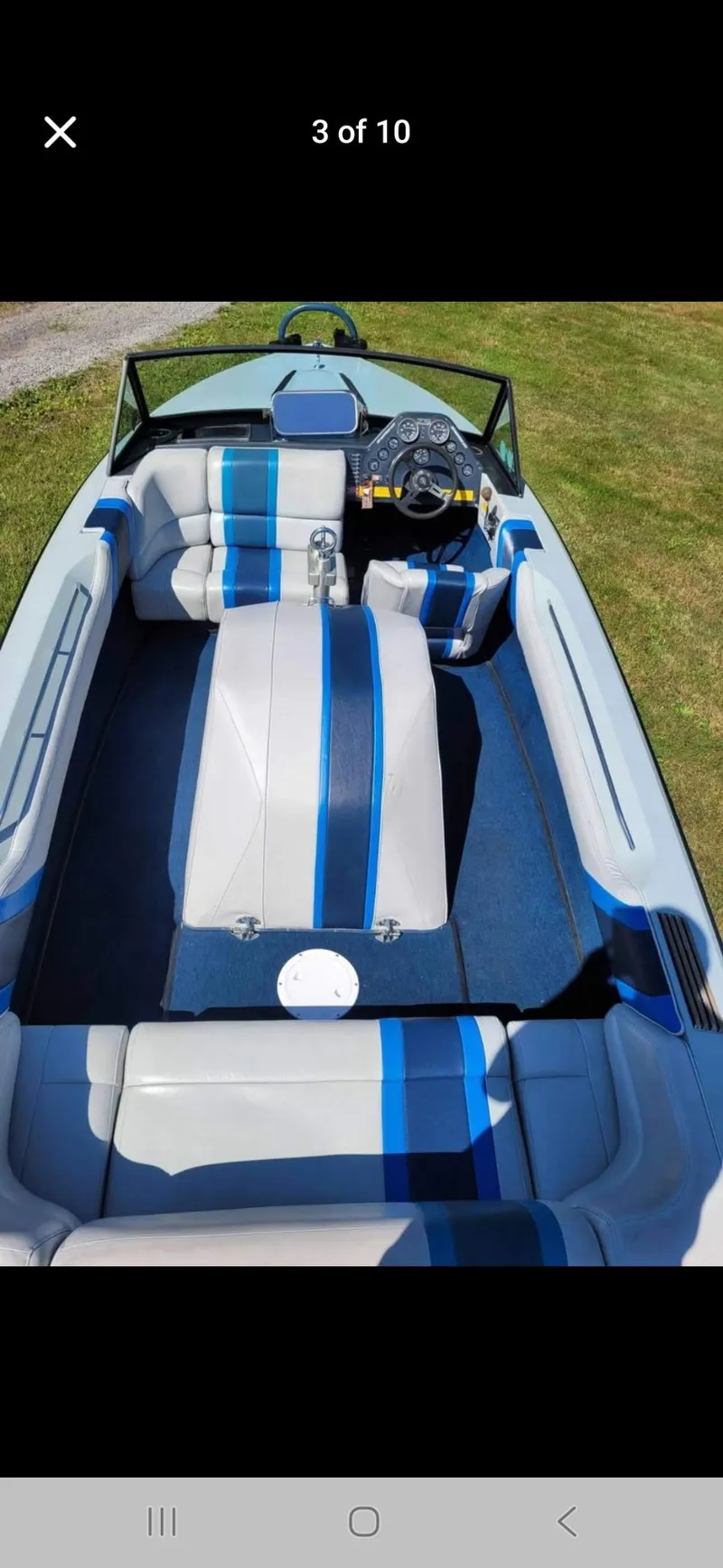 Slide: The Image of 1986 Correct Craft Ski Nautique boat interior with blue and gray upholstery, steering wheel, and seating. - 5