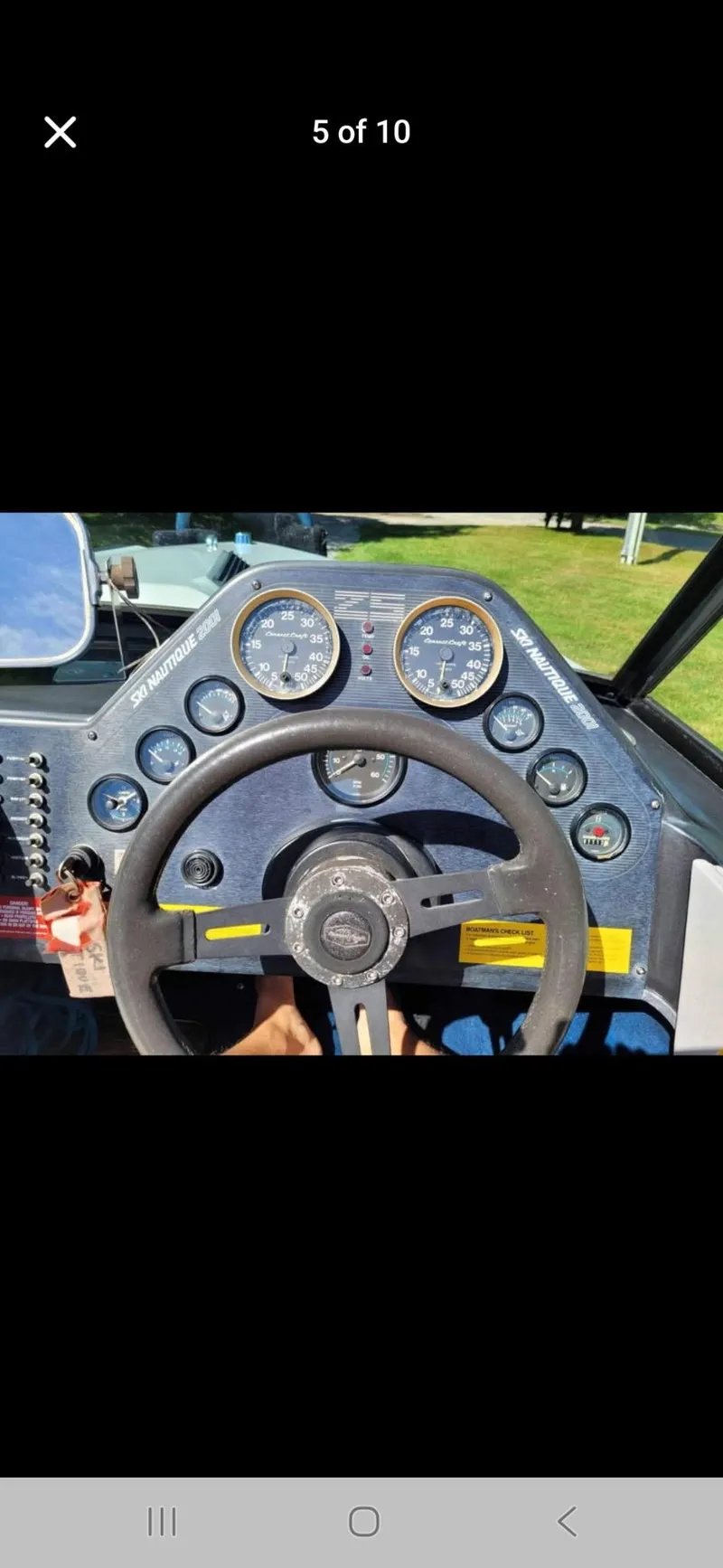 Slide: The Image of 1986 Correct Craft Ski Nautique dashboard with steering wheel and gauges. - 8