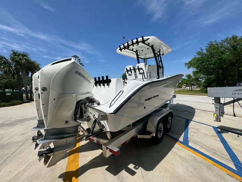 Slide: The Image of 2025 Cape Horn 27 XS boat on trailer, featuring dual outboard engines, under a clear blue sky. - 10