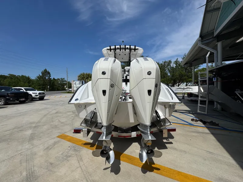 Slide: The Image of 2025 Cape Horn 27 XS boat with dual outboard engines in a sunny marina. - 13