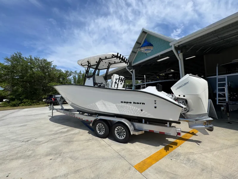Slide: The Image of 2025 Cape Horn 27 XS boat on trailer outside a marine facility. - 16