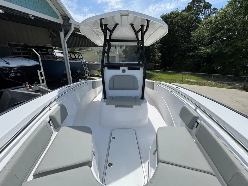 Slide: The Image of 2025 Cape Horn 27 XS boat interior with seating and console, docked outdoors. - 21