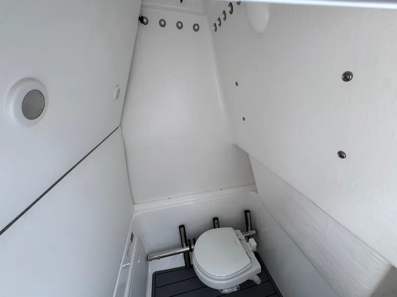 Slide: The Image of 2025 Cape Horn 27 XS boat interior with compact marine toilet. - 26