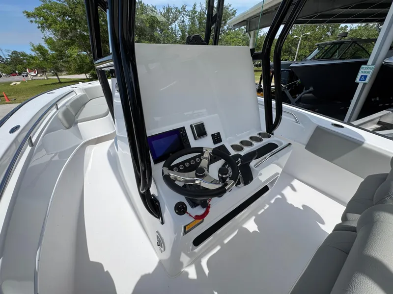 Slide: The Image of 2025 Cape Horn 27 XS boat cockpit with steering wheel and control panel. - 27