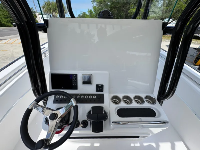 Slide: The Image of 2025 Cape Horn 27 XS boat console with steering wheel and control panel. - 28