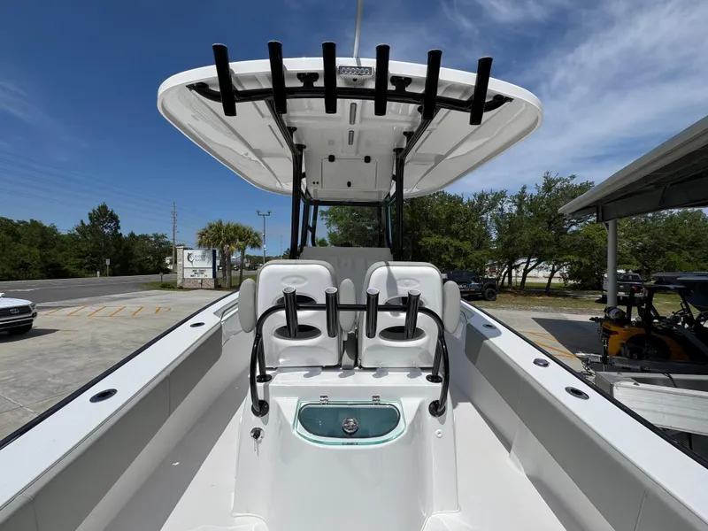 Slide: The Image of 2025 Cape Horn 27 XS boat interior with seating and rod holders under a clear blue sky. - 34
