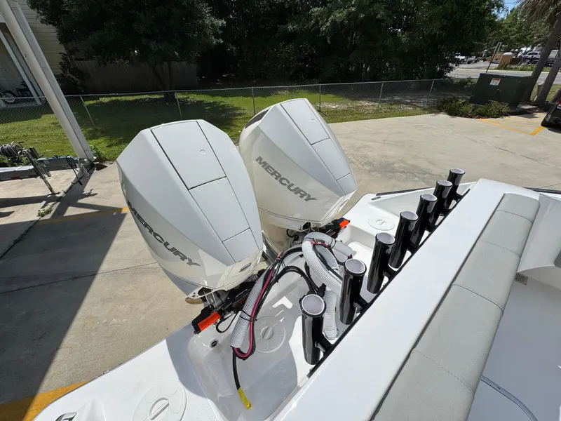 Slide: The Image of 2025 Cape Horn 27 XS boat with dual Mercury outboard engines, docked outdoors. - 38