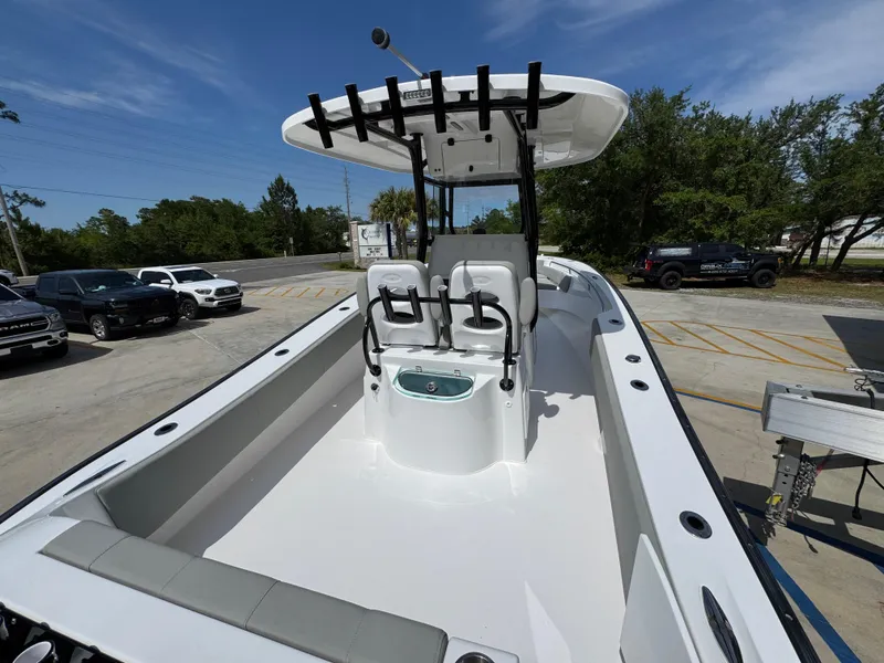 Slide: The Image of 2025 Cape Horn 27 XS boat with dual seats and spacious deck in a parking lot. - 39