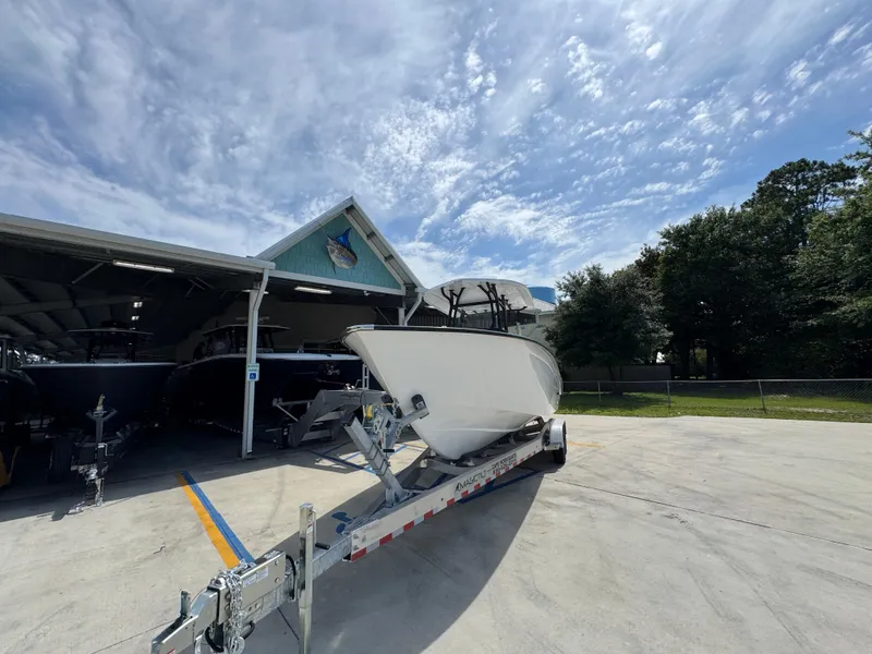 Slide: The Image of 2025 Cape Horn 27 XS boat on trailer under a partly cloudy sky. - 5
