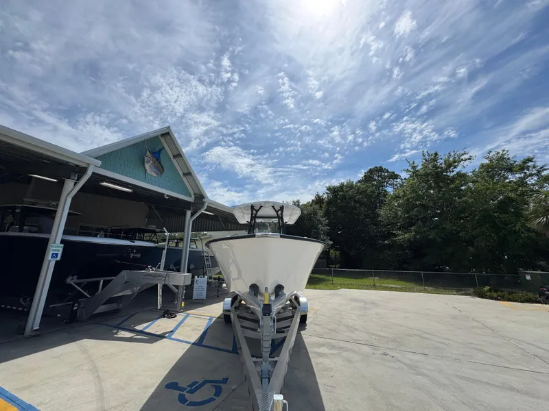 Slide: The Image of 2025 Cape Horn 27 XS boat on trailer under a partly cloudy sky. - 7