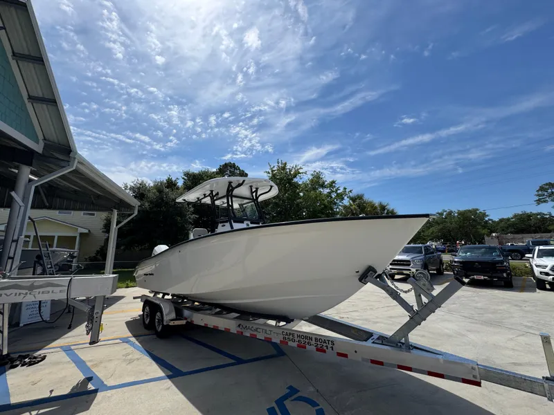Slide: The Image of 2025 Cape Horn 27 XS boat on trailer under a clear blue sky. - 8