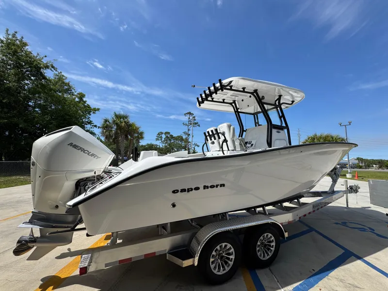 Slide: The Image of 2025 Cape Horn 27 XS boat on trailer, featuring Mercury outboard engine, under clear blue sky. - 9