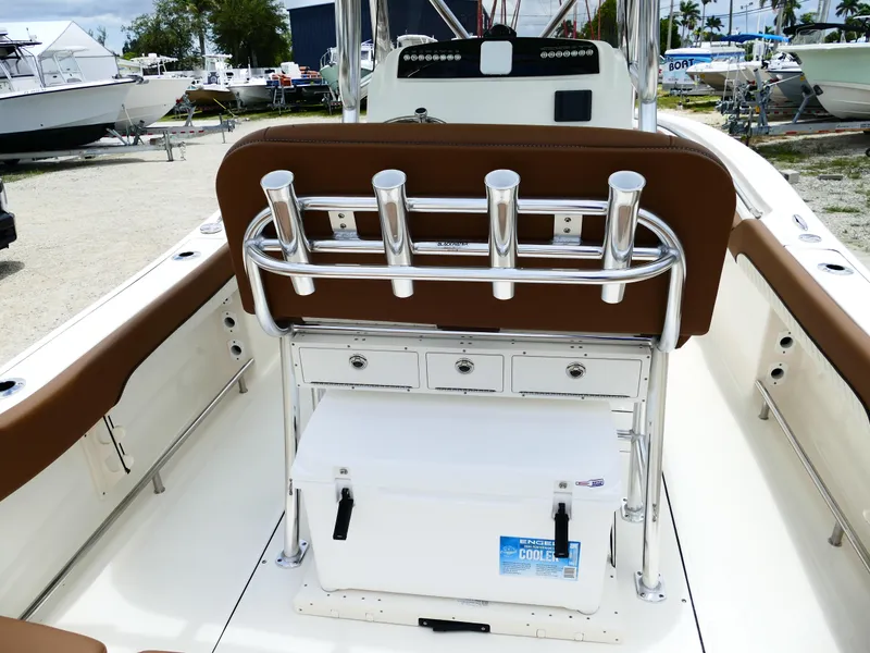 Slide: The Image of 2026 Pioneer 222 Islander boat interior with rod holders and cooler on deck. - 13