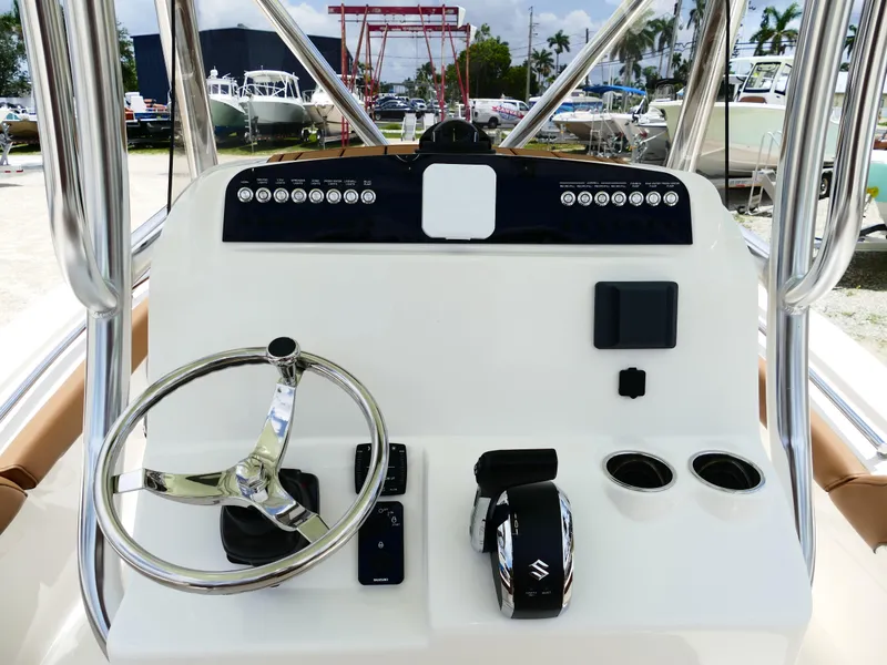 Slide: The Image of 2026 Pioneer 222 Islander boat dashboard with steering wheel and controls. - 21