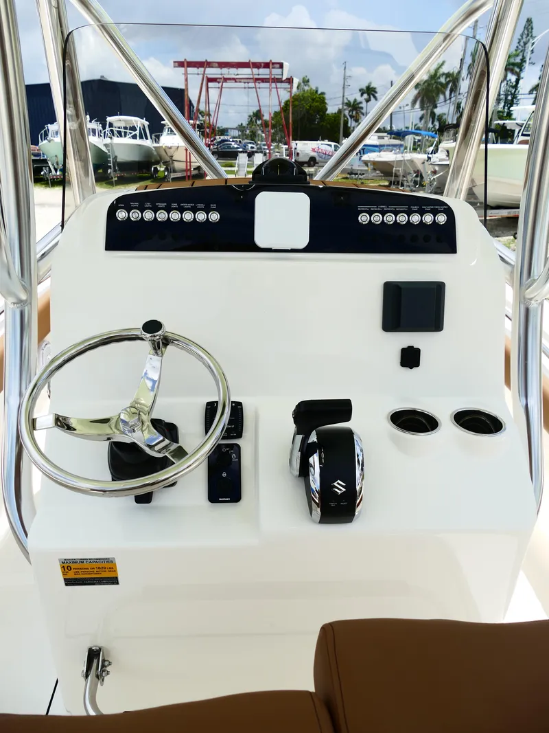Slide: The Image of 2026 Pioneer 222 Islander boat console with steering wheel and controls. - 22