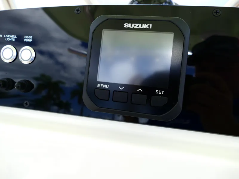Slide: The Image of Control panel of 2026 Pioneer 222 Islander boat with Suzuki display and buttons. - 26