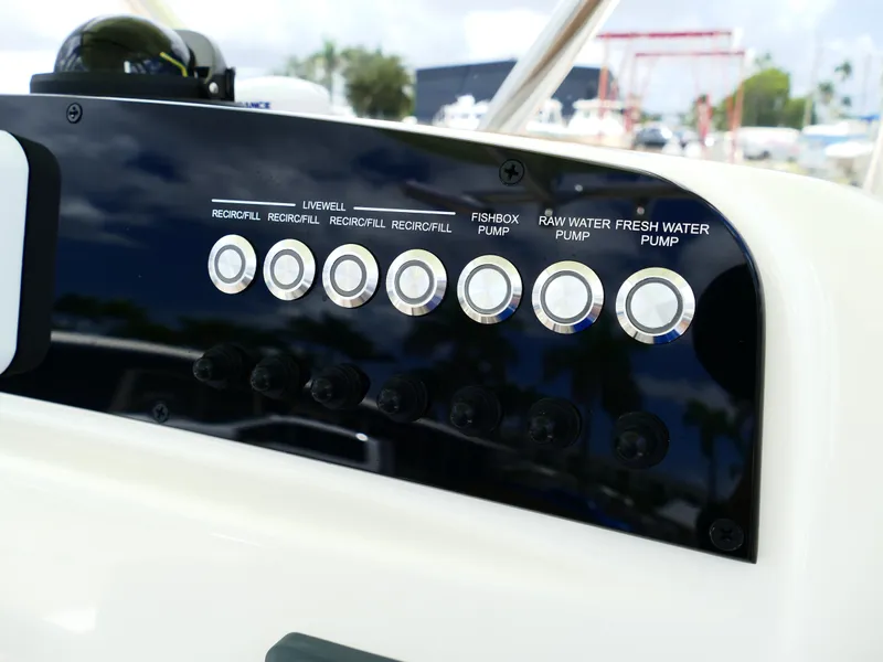 Slide: The Image of Control panel of 2026 Pioneer 222 Islander boat with pump switches. - 27