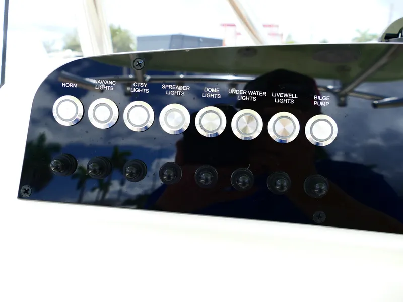 Slide: The Image of Control panel of 2026 Pioneer 222 Islander boat with labeled switches. - 28