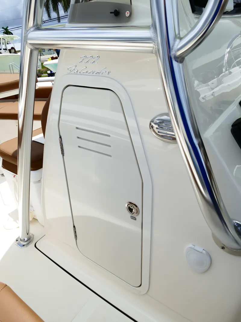 Slide: The Image of 2026 Pioneer 222 Islander boat console with storage compartment and sleek design. - 33