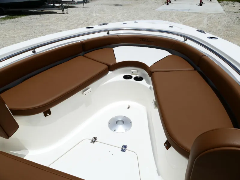 Slide: The Image of 2026 Pioneer 222 Islander boat interior with brown cushioned seating. - 41