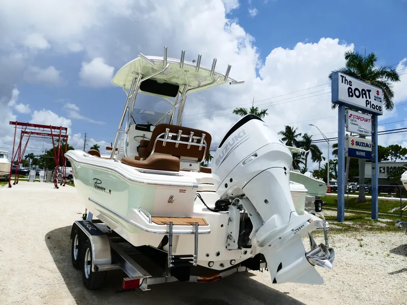 Slide: The Image of 2026 Pioneer 222 Islander boat with Suzuki engine at dealership, sunny day. - 6