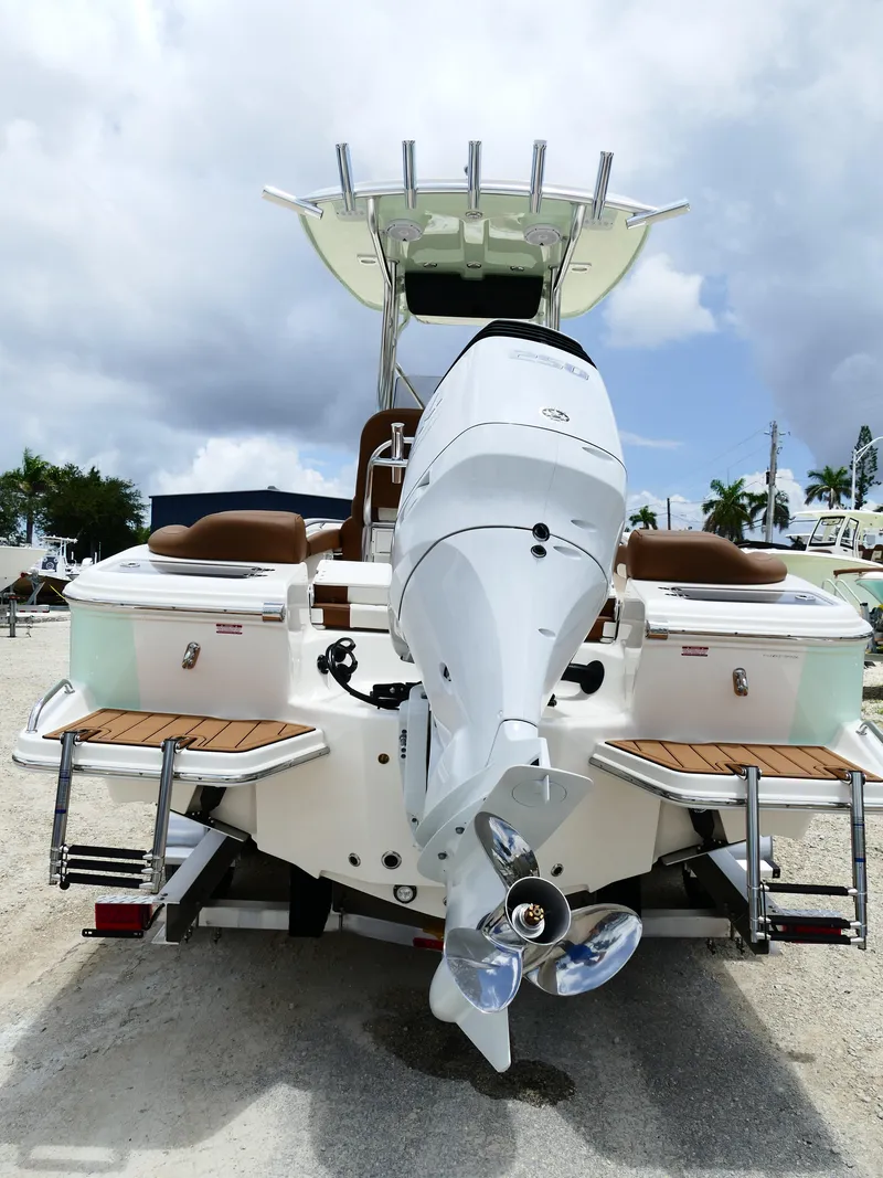 Slide: The Image of 2026 Pioneer 222 Islander boat with outboard motor, rear view, on a sunny day. - 8