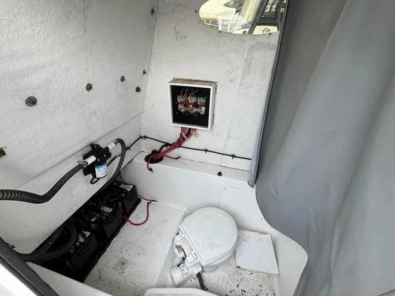 Slide: The Image of 2024 Clearwater 2500 boat interior with toilet and electrical panel. - 11