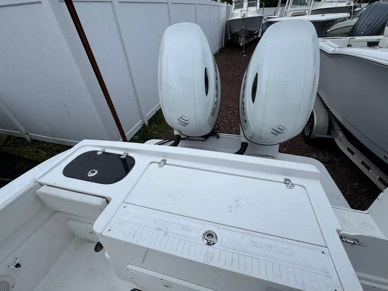 Slide: The Image of 2024 Clearwater 2500 boat with dual outboard engines, white deck, and storage compartments. - 12