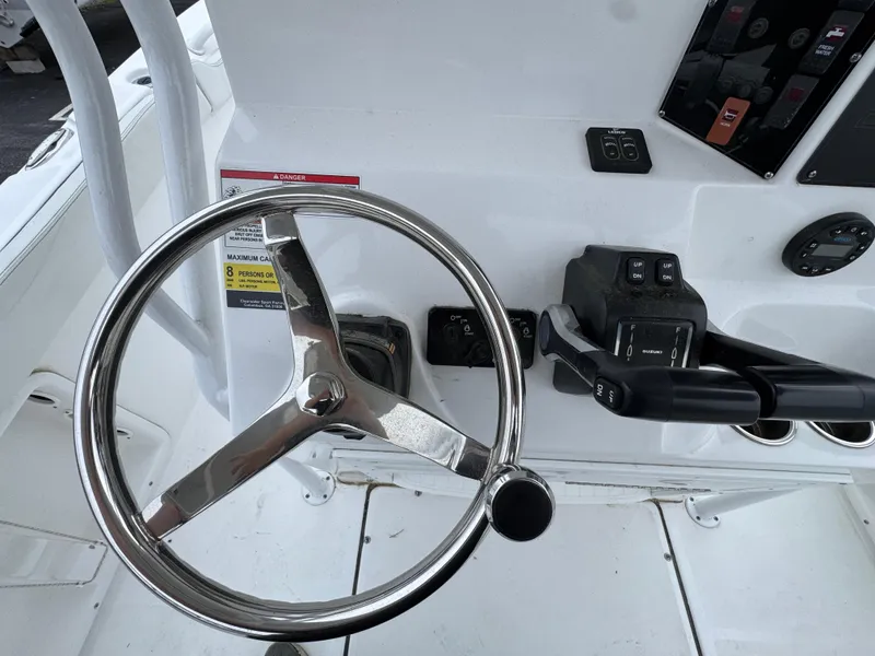 Slide: The Image of Steering wheel and controls of 2024 Clearwater 2500 boat cockpit. - 18