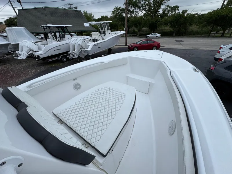 Slide: The Image of 2024 Clearwater 2500 boat with spacious seating and sleek design in a parking lot. - 4