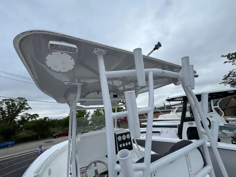 Slide: The Image of 2024 Clearwater 2500 boat with T-top and console, viewed from below on a cloudy day. - 9