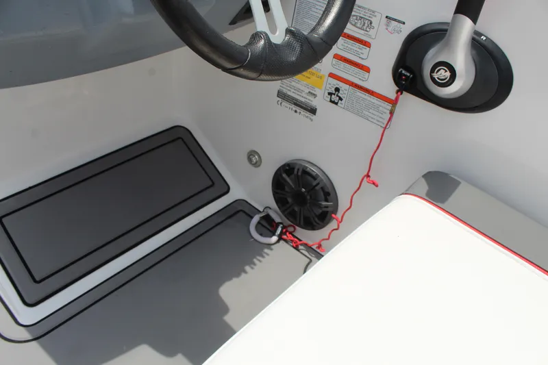 Slide: The Image of 2023 Tahoe T18 boat interior with steering wheel and safety features. - 12