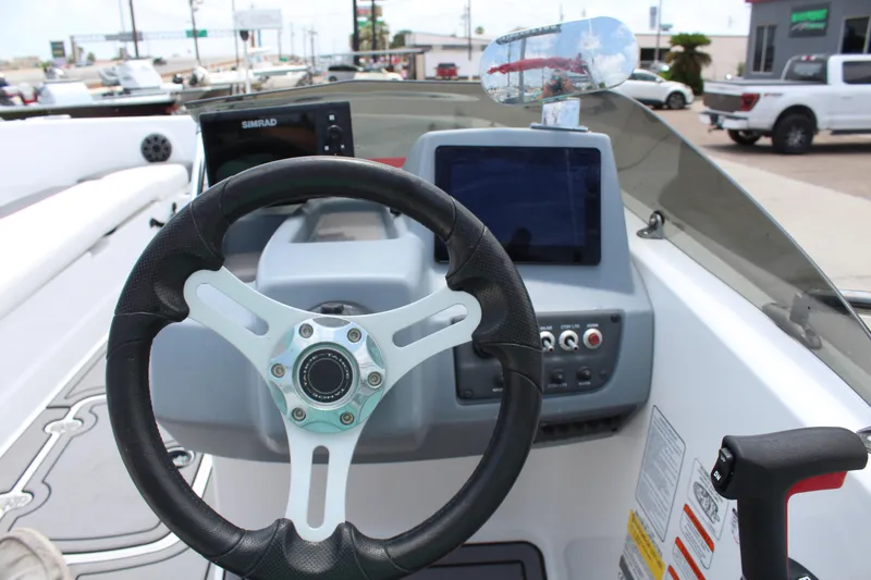 Slide: The Image of 2023 Tahoe T18 boat dashboard with steering wheel and digital displays. - 14