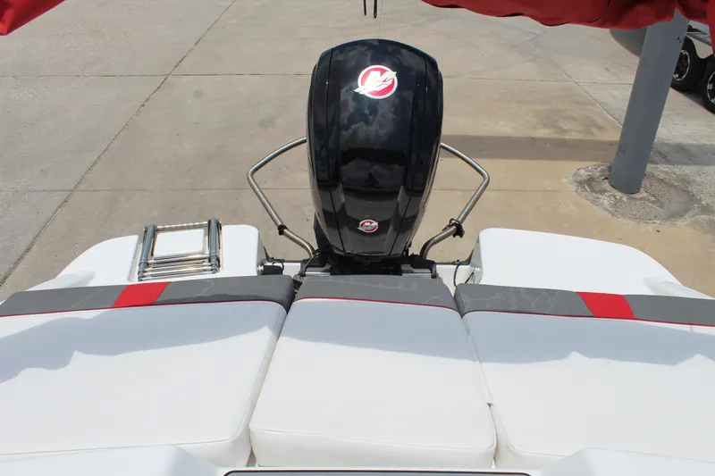 Slide: The Image of 2023 Tahoe T18 boat with outboard motor and cushioned seating, docked on concrete. - 15