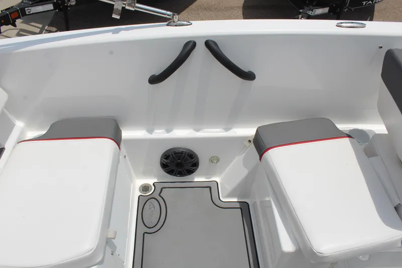 Slide: The Image of 2023 Tahoe T18 boat interior with cushioned seating and speaker. - 16